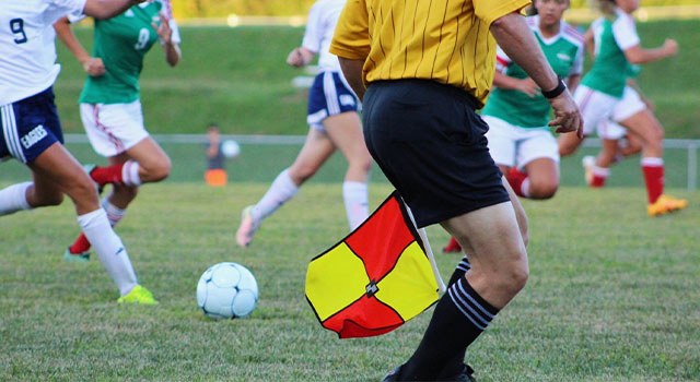men playing soccer on a field