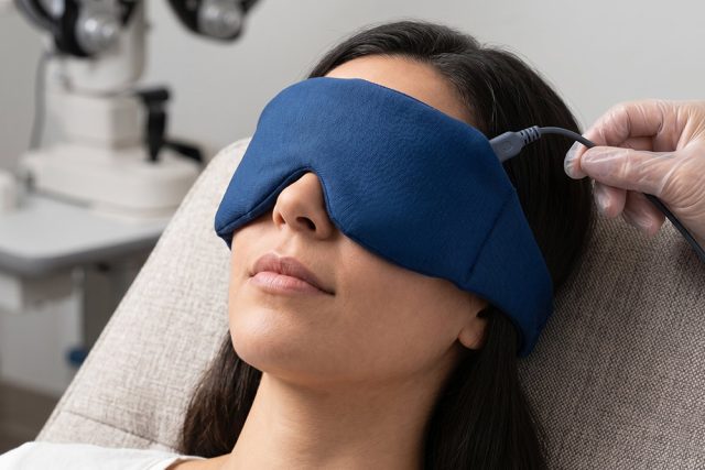 Woman using warm compress for dry eye treatment 640x427