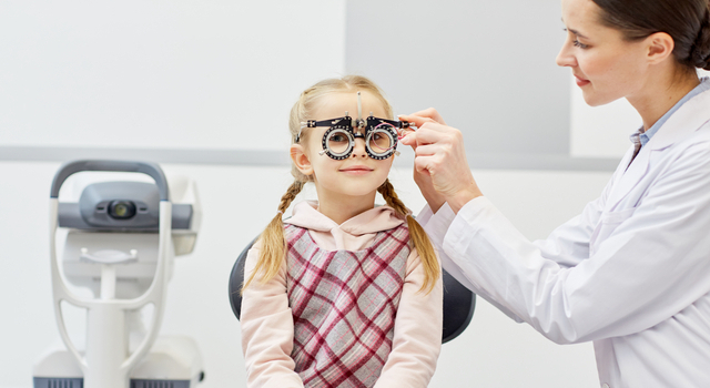 little girl undergoing an eye exam