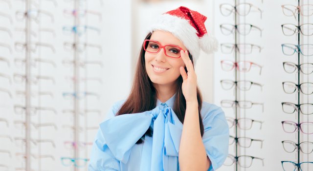 young woman red eyeglasses in optical store